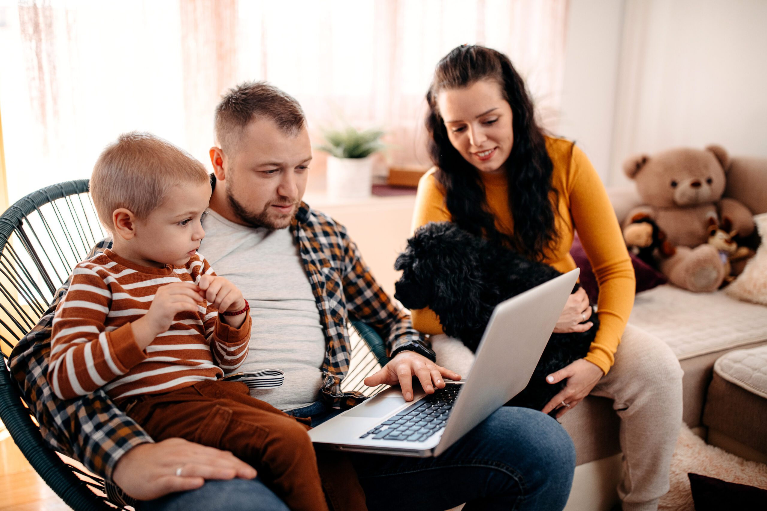 Happy family together shopping online with a dog